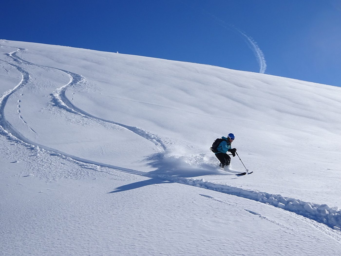 A skier making powder turns off-piste at Chamonix-Mont-Blanc, France