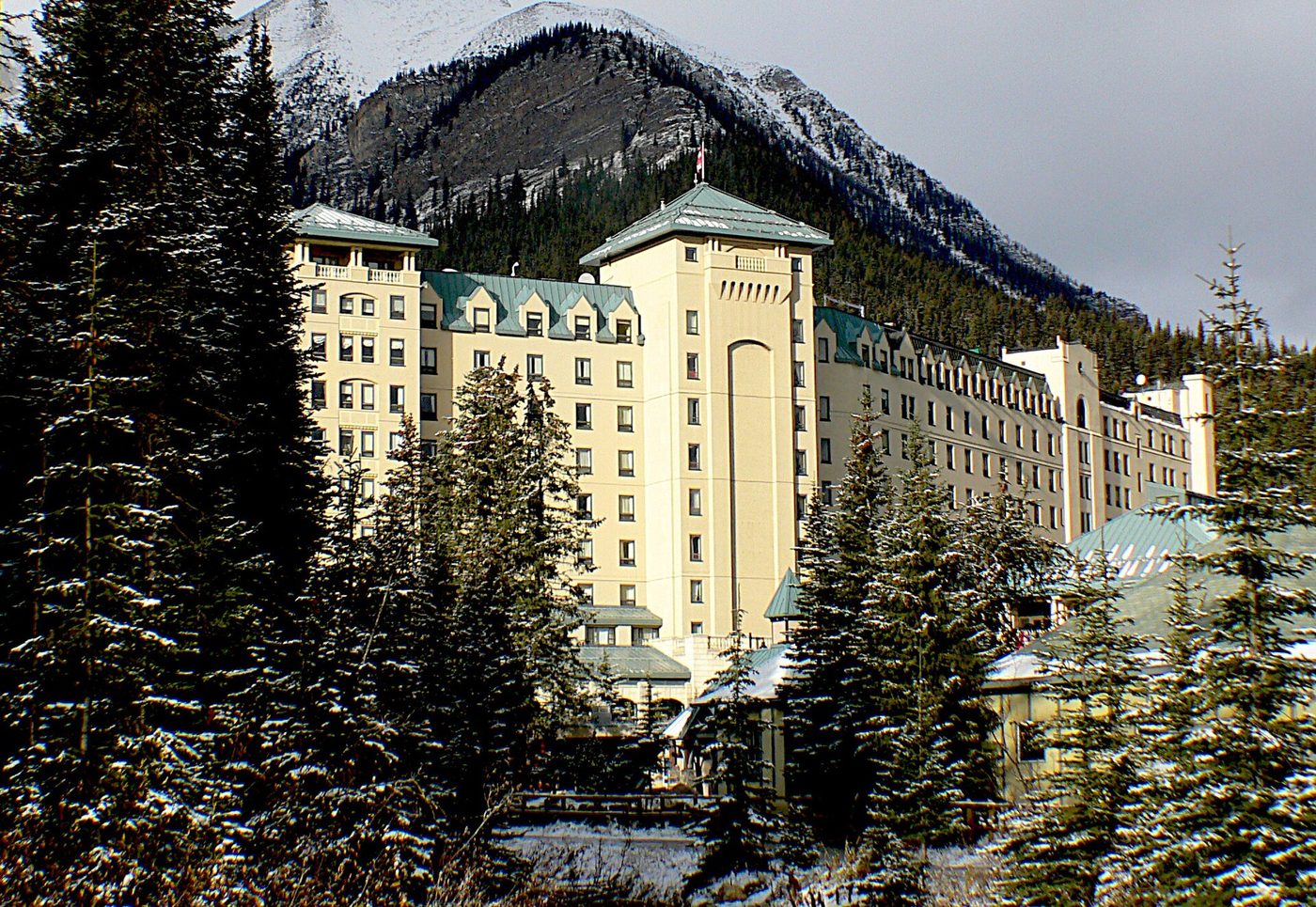 The Fairmont Chateau Lake Louise below snow-covered peaks, Alberta