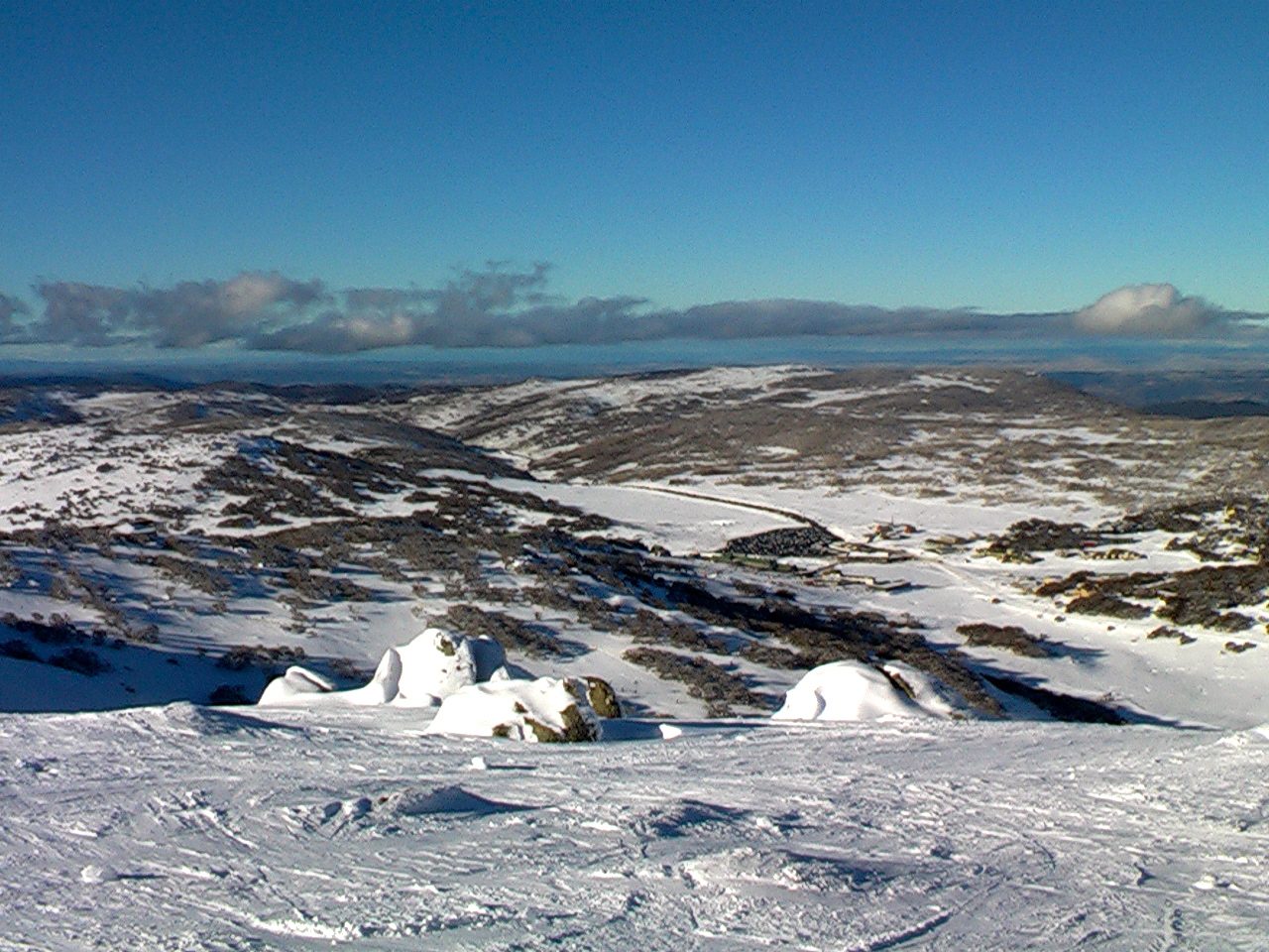 The rolling, sparsely snow-covered terrain of the Snowy Mountains near Perisher, New South Wales, Australia